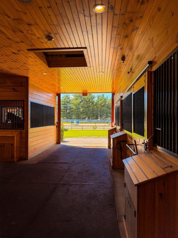 The barn aisle looking out to the outdoor arena